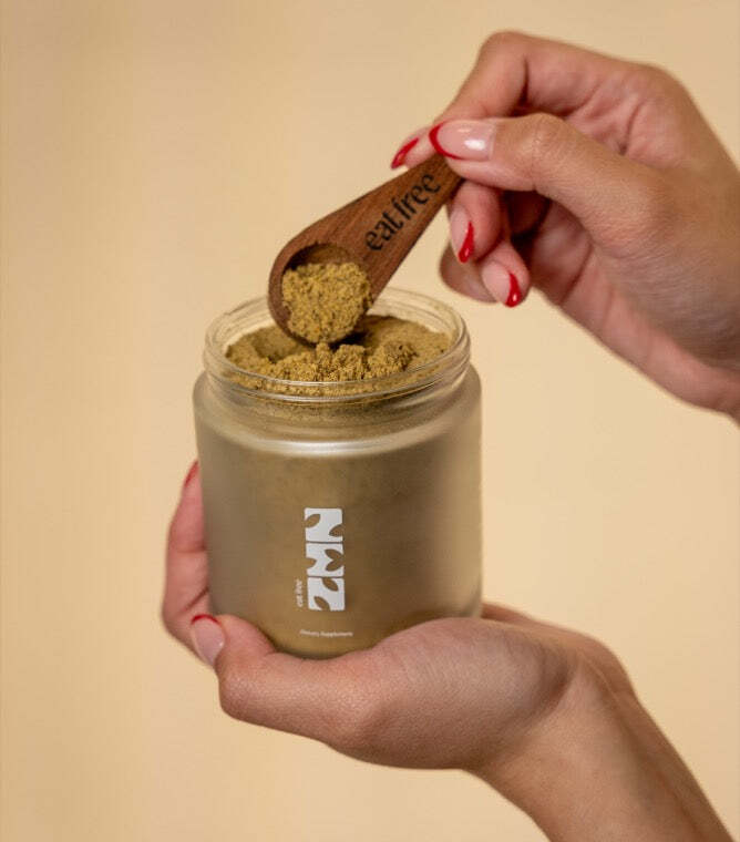 Scooping ZEN Eat Free into the jar